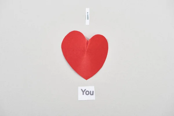 Top view of i love you lettering with paper heart on grey background — Stock Photo