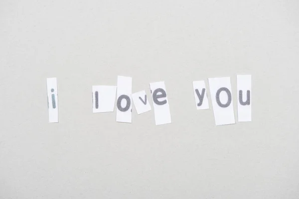 Top view of i love you lettering on papers isolated on grey — Fotografia de Stock