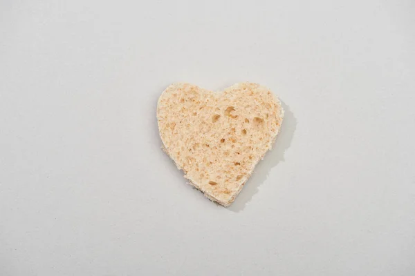 Top view of heart shape from bread on grey background — Stock Photo