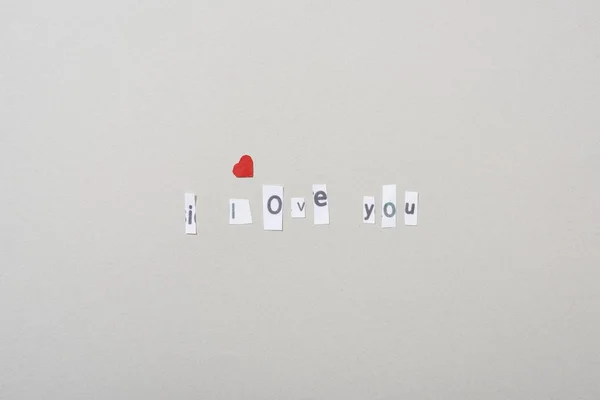 Top view of i love you lettering with paper heart isolated on grey — Stock Photo