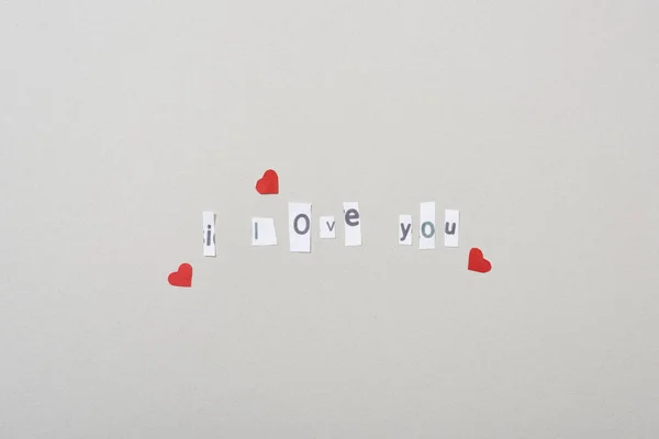 Top view of paper hearts and i love you lettering isolated on grey — Stock Photo