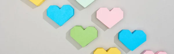 Top view of decorative papers in heart shape on grey background, panoramic shot — Stock Photo