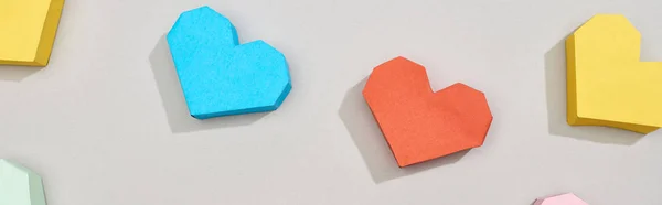 Top view of decorative heart shaped papers on grey background, panoramic shot — Stock Photo