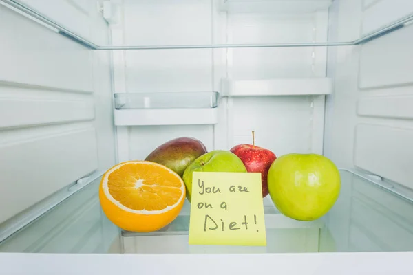 Card with you are on a diet lettering and fresh fruits in fridge — Stock Photo