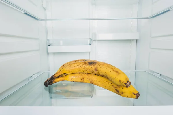 Two fresh bananas on shelf on refrigerator — Stock Photo