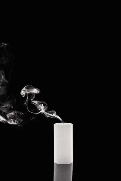 Extinct white candle with smoke on black background — Stock Photo