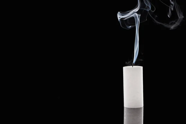 Extinct white candle with smoke on black background — Stock Photo