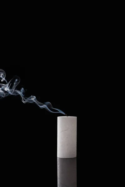 Extinct white candle with smoke on black background — Stock Photo