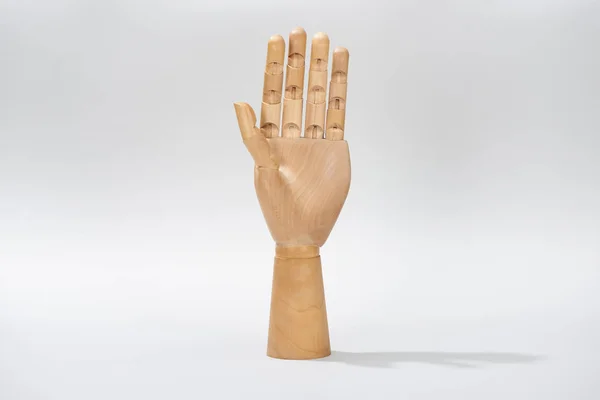 Hand of wooden doll on gray background — Stock Photo