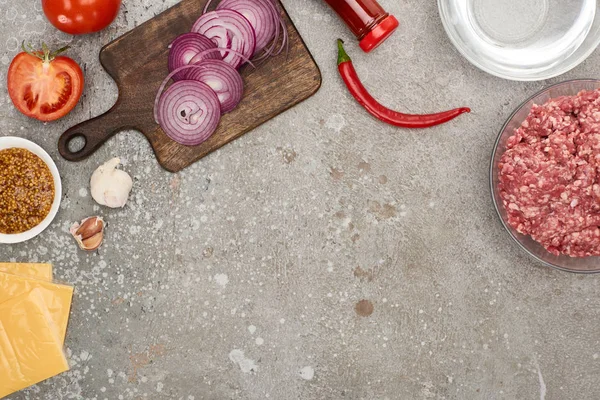 Top view of fresh burger ingredients on grey concrete surface — Stock Photo