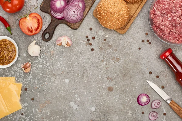 Top view of fresh burger ingredients on grey concrete surface — Stock Photo