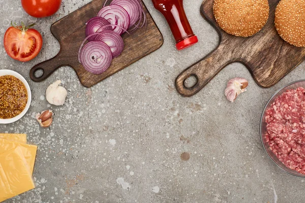 Vista superior de ingredientes de hambúrguer frescos na superfície de concreto cinza — Fotografia de Stock