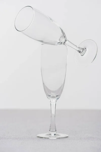 Champagne glasses on tablecloth isolated on grey — Stock Photo