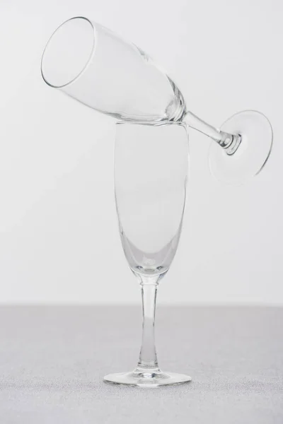 Champagne glasses on tablecloth isolated on grey — Stock Photo