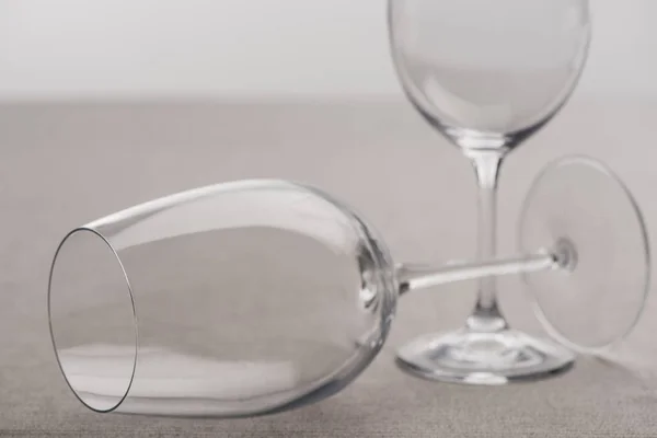 Selective focus of transparent wine glasses isolated on grey — Stock Photo