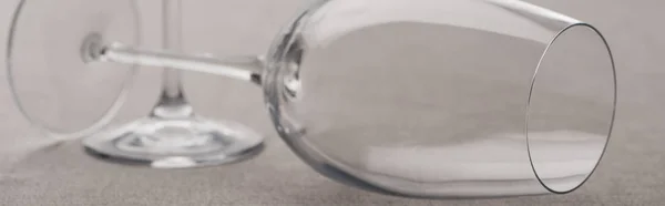 Panoramic shot of clear wine glasses isolated on grey — Stock Photo