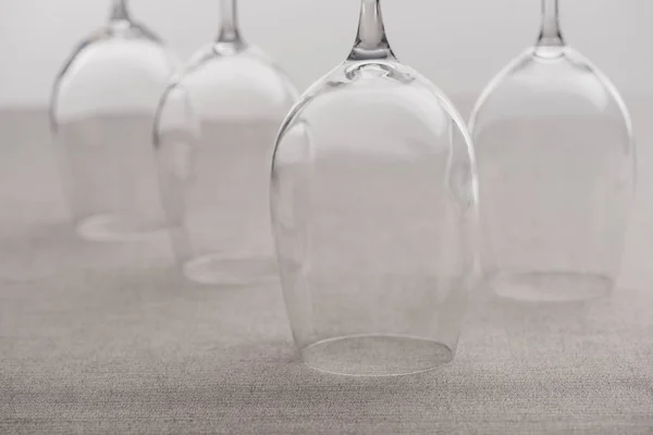 Concentration sélective des verres à vin inversés sur la nappe isolée sur gris — Photo de stock