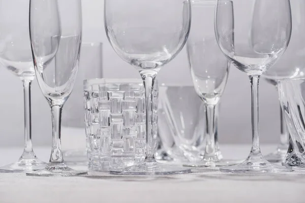 Empty glasses on white surface isolated on grey — Stock Photo