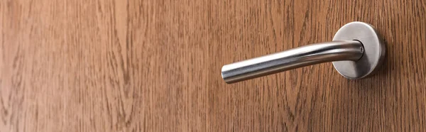 Wooden hotel room door with metal handle, panoramic shot — Stock Photo