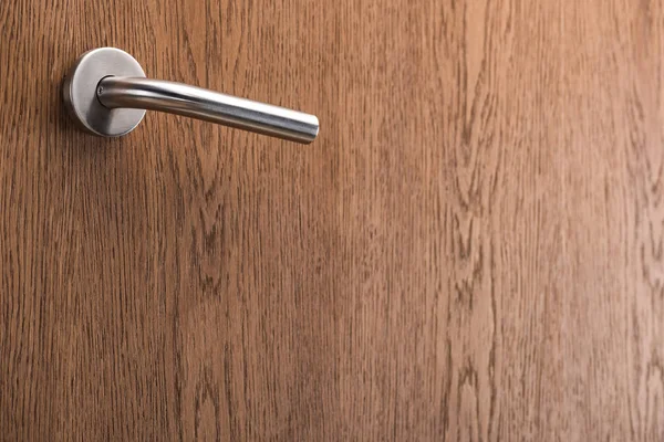 Wooden hotel room door with metal handle — Stock Photo