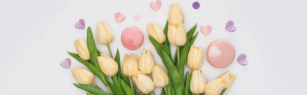 Вид зверху на тюльпани, рожеві макарони і фіолетові серця ізольовані на білому, панорамний знімок — стокове фото