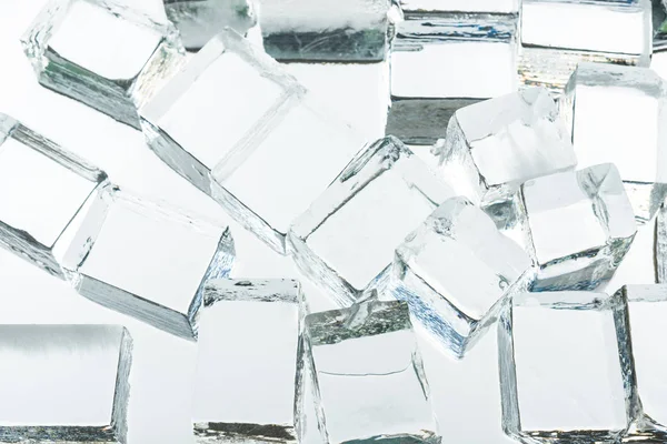 Transparent clear square ice cubes on mirror — Stock Photo