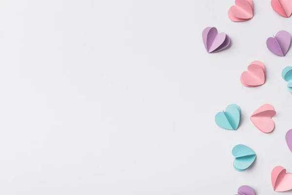 Top view of colorful paper hearts on white background — Stock Photo
