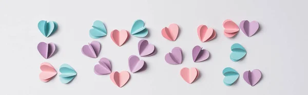 Top view of love lettering made of colorful paper hearts on white background, panoramic shot — Stock Photo