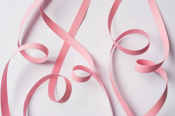 Top view of pink paper swirl on white background — Stock Photo