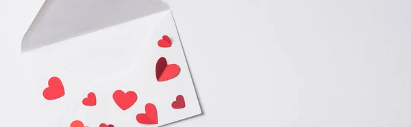 Top view of valentines envelope with red hearts on white background, panoramic shot — Stock Photo