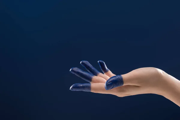 Cropped view of female hand with painted fingers isolated on blue — Stock Photo