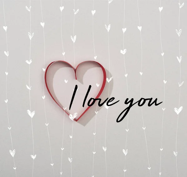 Top view of red paper heart on grey background with i love you lettering — Stock Photo