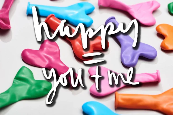 Colorful heart shaped balloons on grey background with happy you and me lettering — Stock Photo