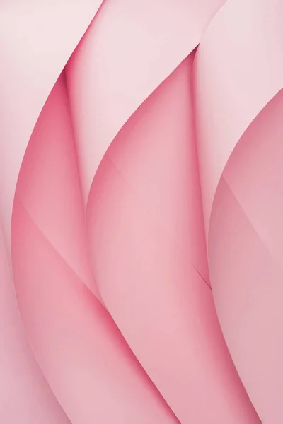 Top view of pink paper swirls on pink background — Stock Photo