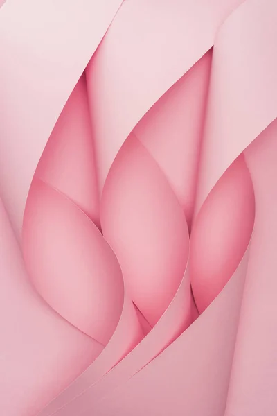 Draufsicht auf rosa Papierwirbel auf rosa Hintergrund — Stockfoto