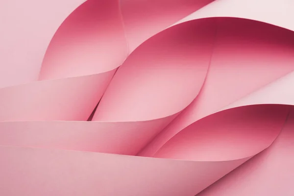 Resumen de remolinos de papel rosa sobre fondo rosa - foto de stock