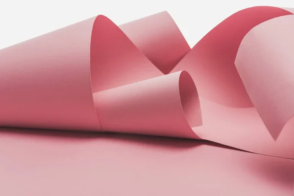 Papier rose tourbillonne avec ombre isolé sur blanc — Photo de stock