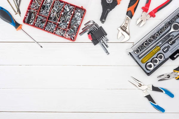 Top view of tool set with tool boxes on white wooden surface — Stock Photo