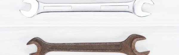 Top view of shiny and rustle on white wooden background, panoramic shot — Stock Photo