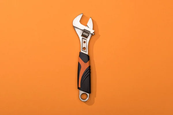 Top view of wrench on orange background — Stock Photo