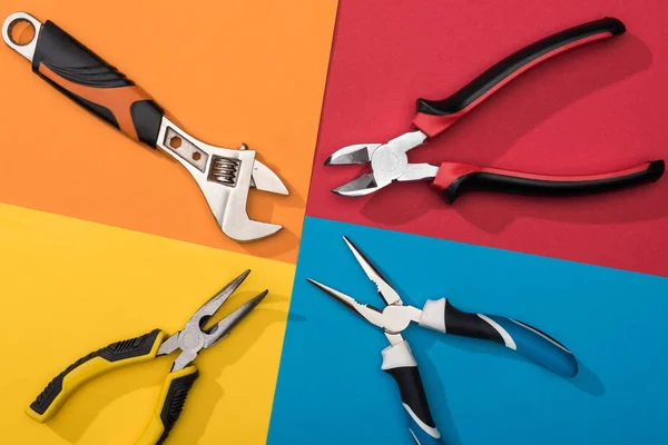 Top view of wrench and pliers on colorful background — Stock Photo