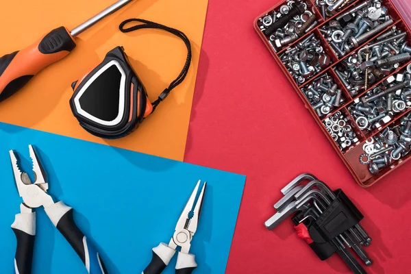 Top view of tool set with pliers and measuring tape on colorful background — Stock Photo