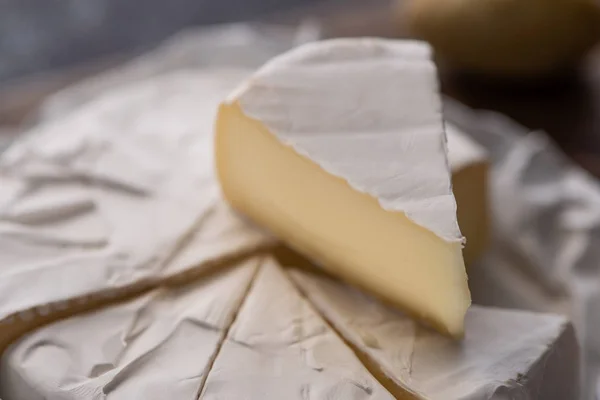 Close up view of cut brie cheese piece — Stock Photo