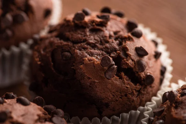 Close up view of fresh chocolate muffin on wooden surface — Stock Photo