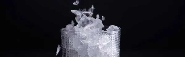 Faceted glass with smashed ice isolated on black, panoramic shot — Stock Photo