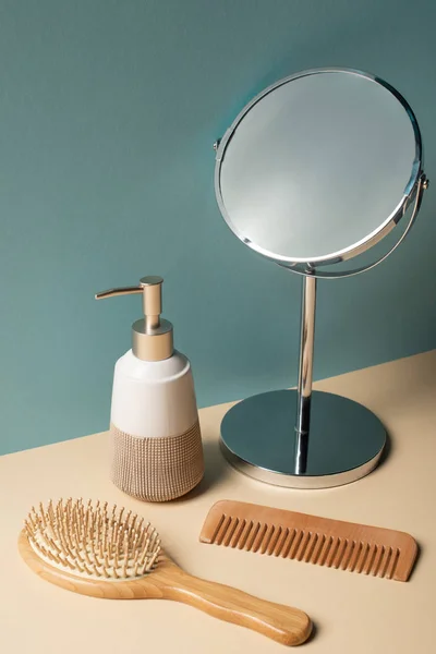 Peine, cepillo para el cabello, dispensador de jabón líquido y espejo en beige y gris, cero concepto de residuos - foto de stock