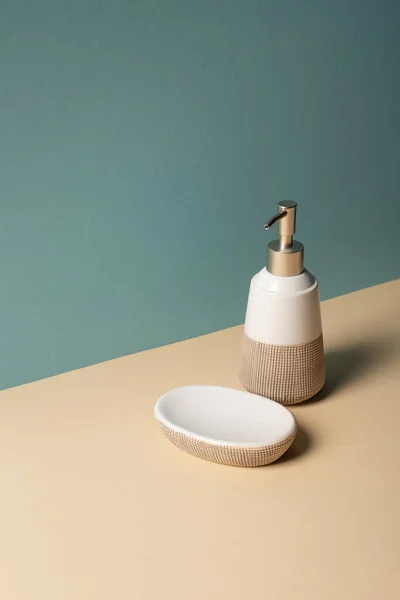 Liquid soap dispenser and soap dish on beige and grey, zero waste concept — Stock Photo