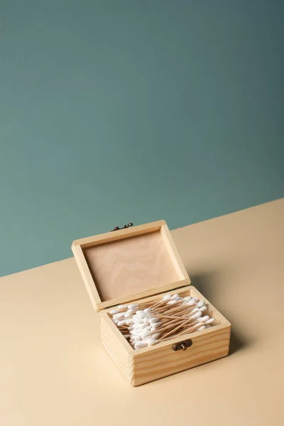 Box with ear sticks on beige and grey, zero waste concept — Stock Photo