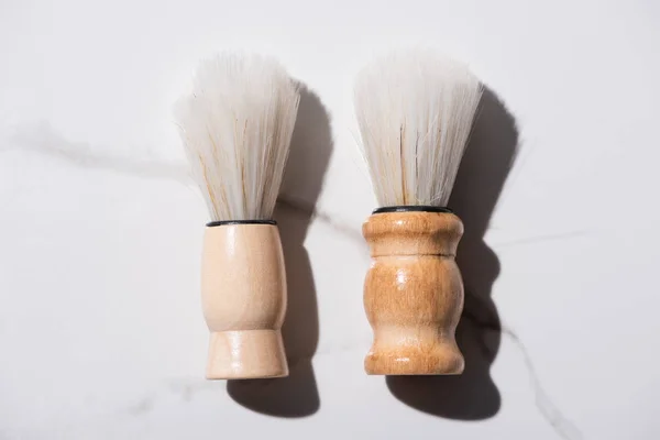 Top view of shaving brushes on white background, zero waste concept — Stock Photo