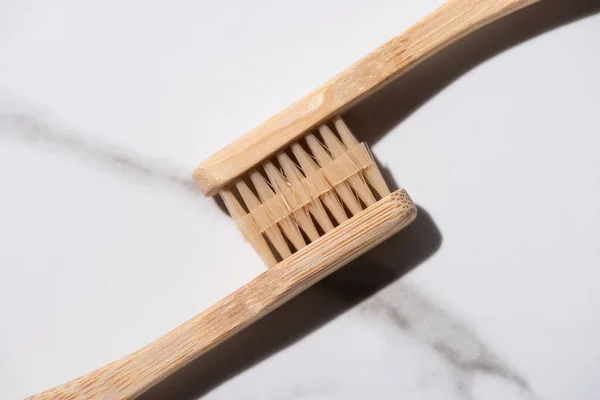 Vista superior de cepillos de dientes conectados sobre fondo blanco, concepto de cero residuos - foto de stock